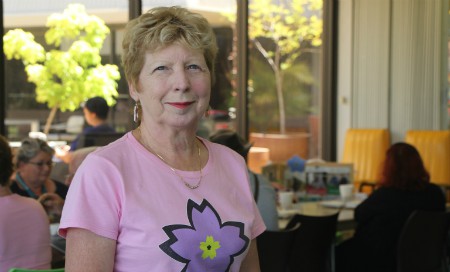 Angi McCluskey wearing pink flower shirt standing in Fremantle Hospital cafe