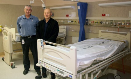 Two men standing in a hospital room with new equipment