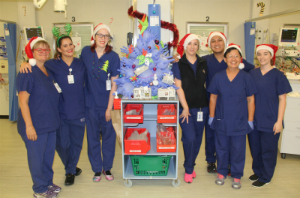 Recovery Theatre clinical staff standing around a Christmas tree made from blue surgical gloves