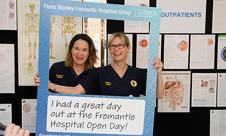 Two female nurses hold a cut out frame in front of them that reads 'I had a great day at the Fremantle Hospital Open Day'.